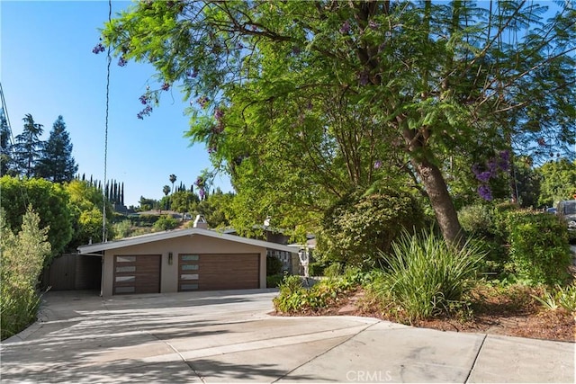 exterior space with a garage, driveway, and stucco siding