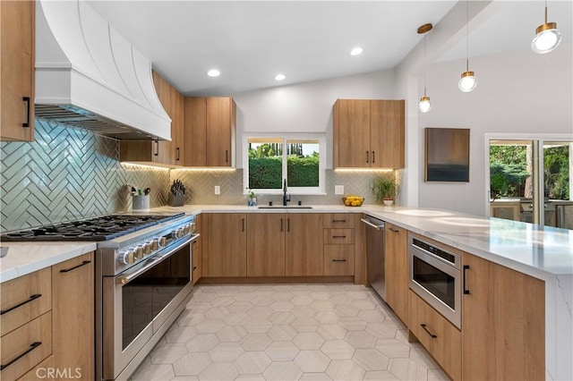 kitchen with premium range hood, decorative light fixtures, a peninsula, stainless steel appliances, and a sink