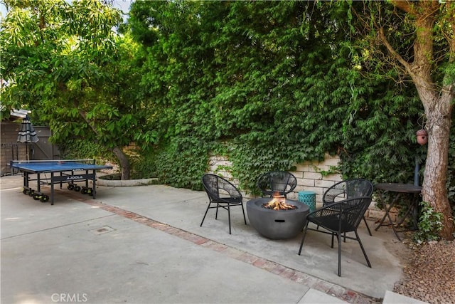 view of patio / terrace with a fire pit and fence