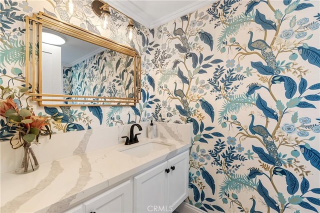 bathroom with ornamental molding, vanity, and wallpapered walls