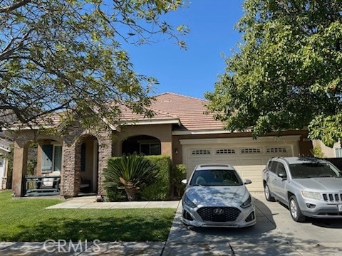 view of front of property featuring a garage and a front lawn