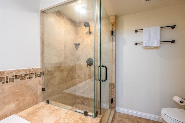 bathroom featuring toilet and walk in shower