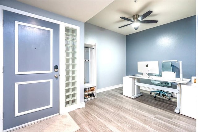 home office with baseboards, ceiling fan, and wood finished floors