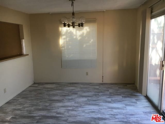 unfurnished dining area with a notable chandelier