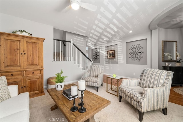 carpeted living room with ceiling fan