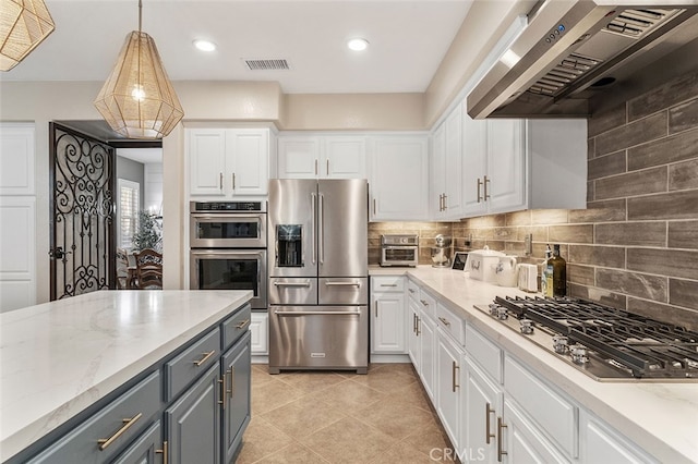 kitchen with stainless steel appliances, wall chimney range hood, and white cabinetry