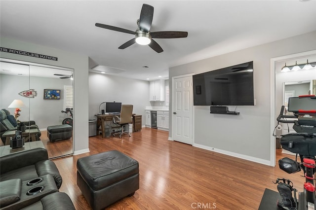 living room with wine cooler, light wood-type flooring, and ceiling fan