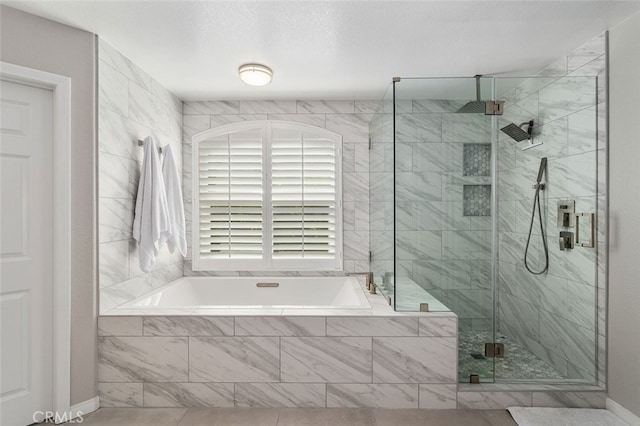 bathroom featuring tile patterned flooring and separate shower and tub