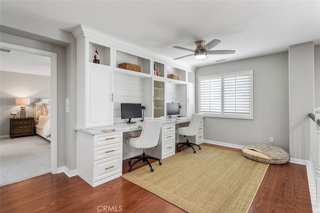 office featuring dark hardwood / wood-style floors and ceiling fan