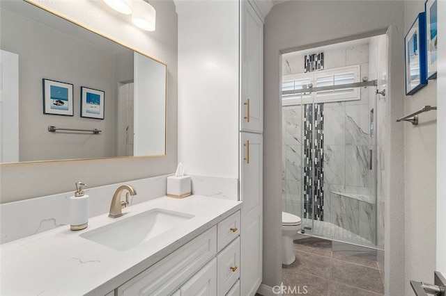 bathroom with tile patterned flooring, an enclosed shower, vanity, and toilet