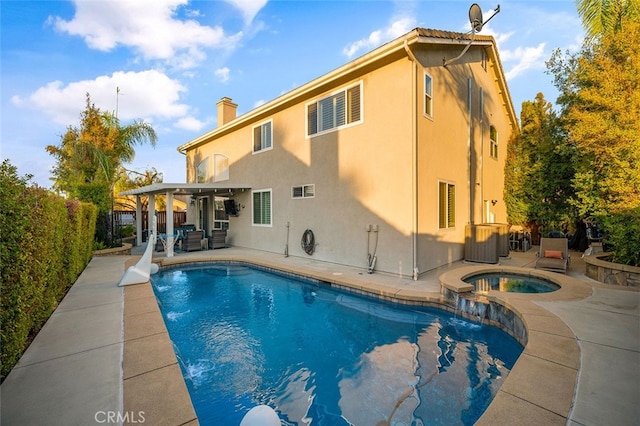 view of pool featuring an in ground hot tub and a patio area