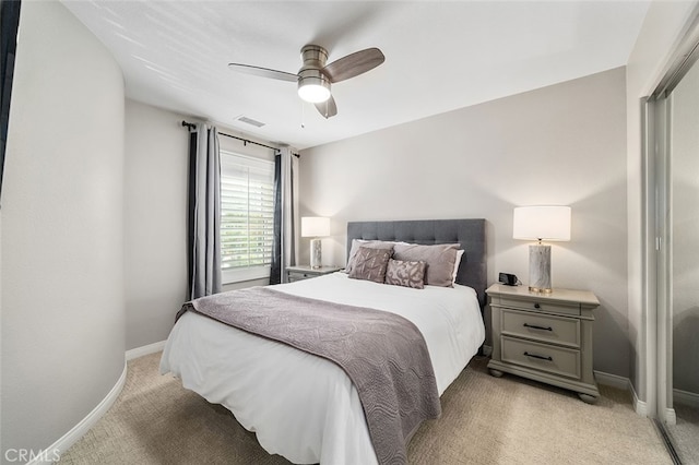 bedroom featuring light carpet, ceiling fan, and a closet