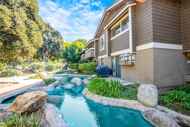 view of pool featuring grilling area