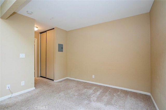 unfurnished room with light carpet and electric panel