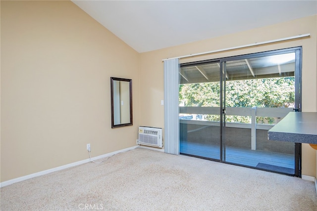 spare room featuring an AC wall unit, a wealth of natural light, vaulted ceiling, and light colored carpet