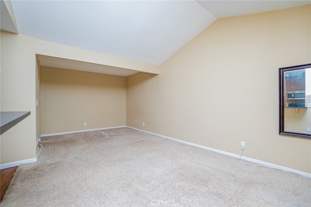 unfurnished living room with light carpet and lofted ceiling