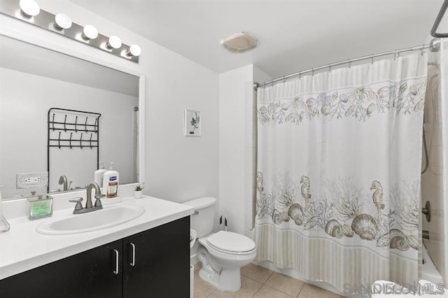 full bathroom featuring tile patterned flooring, shower / bathtub combination with curtain, vanity, and toilet