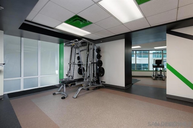 exercise room with a paneled ceiling