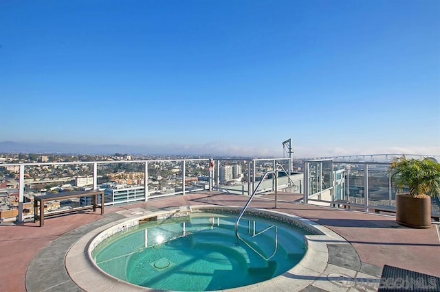 view of swimming pool featuring a hot tub