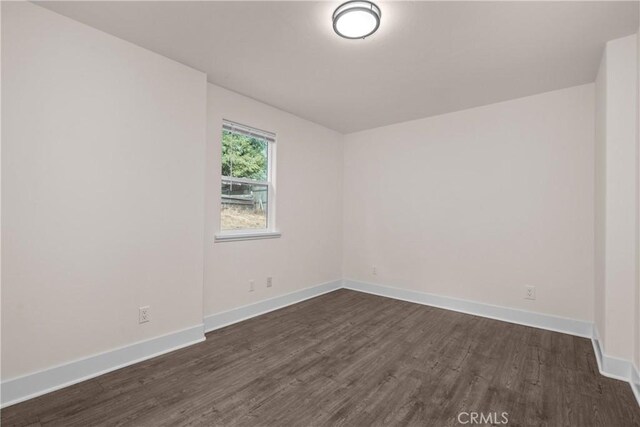 spare room featuring dark hardwood / wood-style flooring