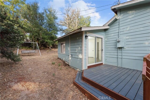 view of side of home featuring a wooden deck