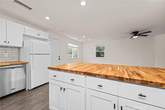 kitchen with wooden counters, white cabinetry, white refrigerator, tasteful backsplash, and stainless steel dishwasher