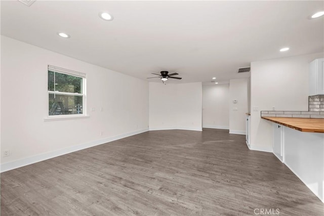 empty room featuring ceiling fan and dark wood-type flooring