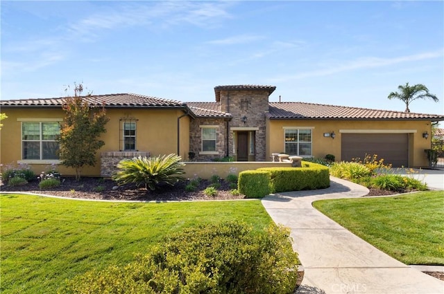 mediterranean / spanish-style home with a garage and a front yard