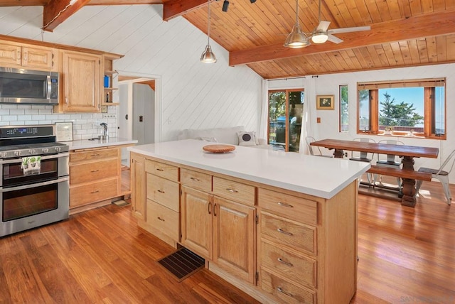 kitchen with appliances with stainless steel finishes, light hardwood / wood-style floors, lofted ceiling with beams, pendant lighting, and ceiling fan