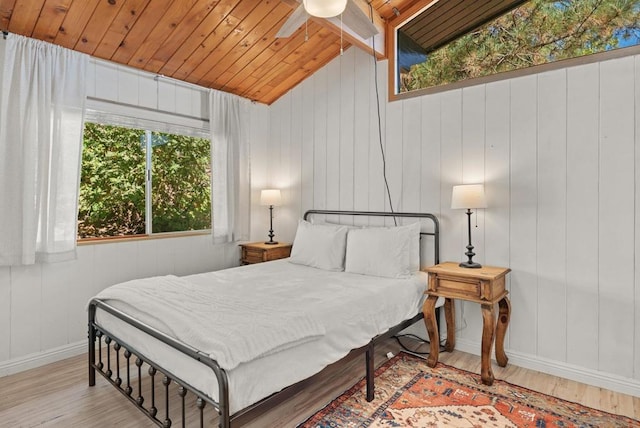 bedroom featuring vaulted ceiling, light hardwood / wood-style floors, wooden ceiling, and ceiling fan