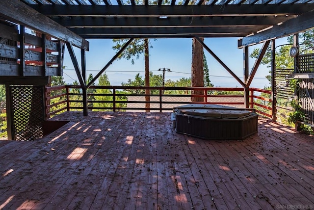 wooden deck featuring a pergola and a hot tub