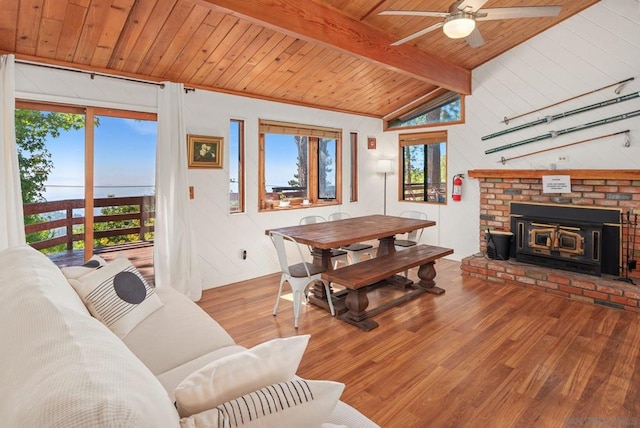 living room with wood ceiling, wood-type flooring, vaulted ceiling with beams, and ceiling fan