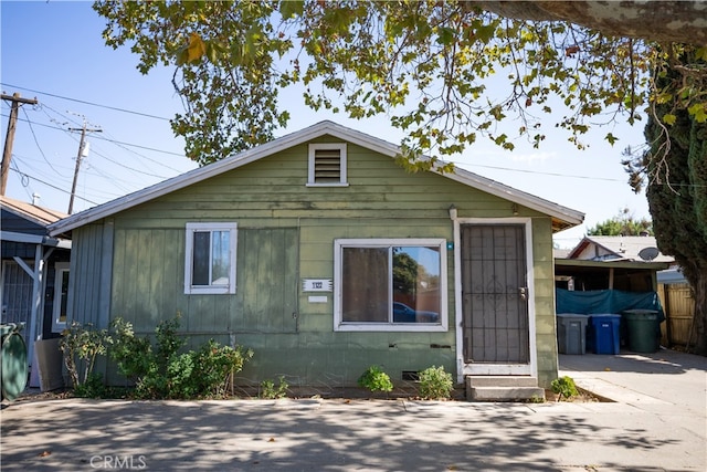 bungalow-style home featuring a carport