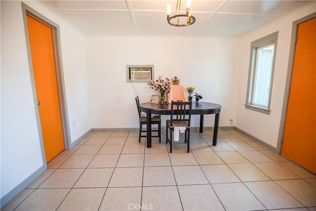 tiled dining room featuring an inviting chandelier and a wall mounted AC