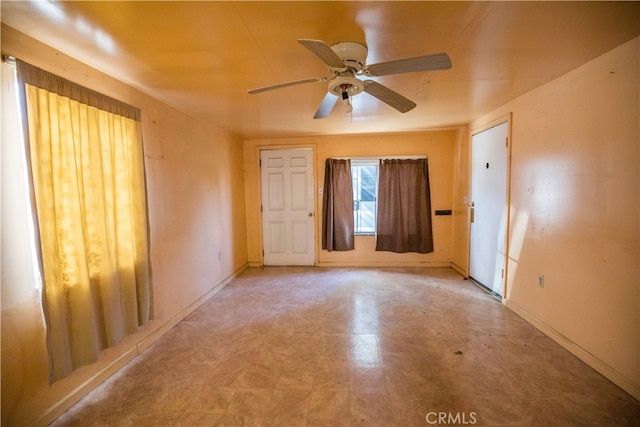 unfurnished room with ceiling fan