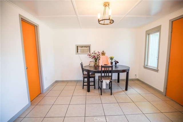 tiled dining space featuring a notable chandelier and a wall mounted AC