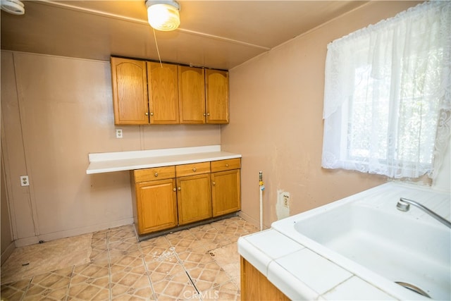 interior space featuring cabinets, light tile patterned floors, and sink