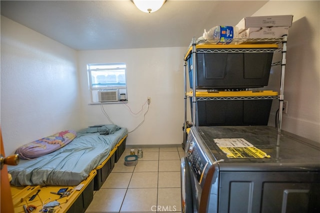 clothes washing area with cooling unit, washer / clothes dryer, and light tile patterned floors