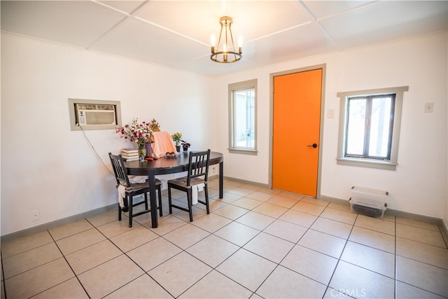 tiled dining area with a notable chandelier and a wall mounted air conditioner