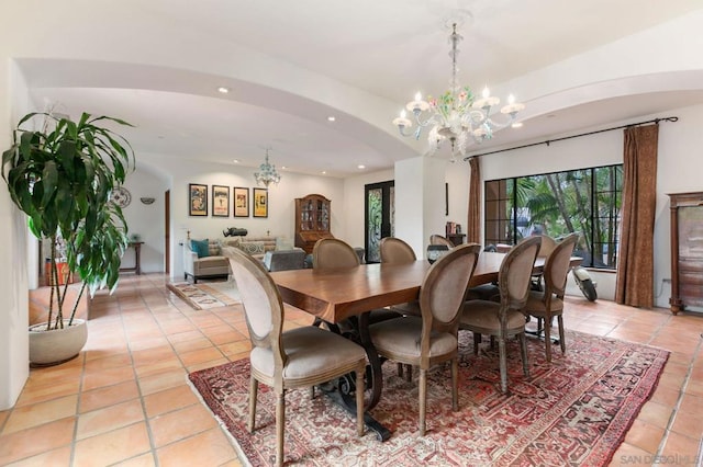 tiled dining space with a chandelier