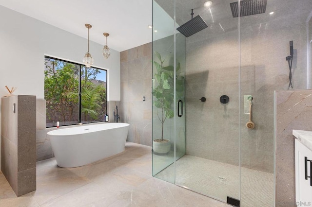 bathroom with tile walls and plus walk in shower