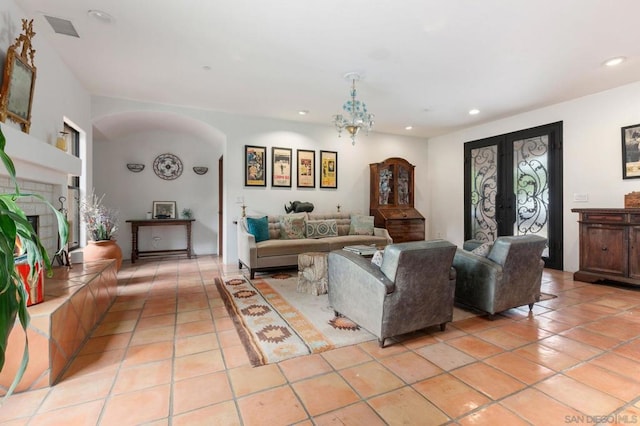 tiled living room featuring french doors and a tile fireplace