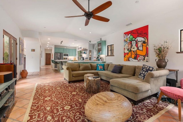 tiled living room with ceiling fan and lofted ceiling