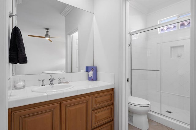 bathroom featuring vanity, ceiling fan, crown molding, tile patterned flooring, and toilet