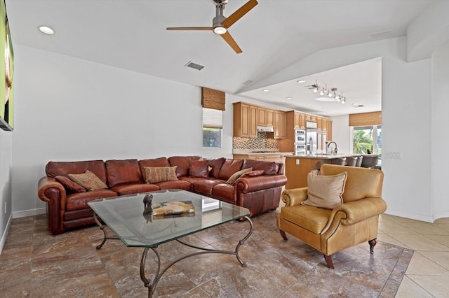 living room with ceiling fan and lofted ceiling