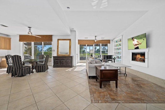 living room with light tile patterned floors, vaulted ceiling, and ceiling fan