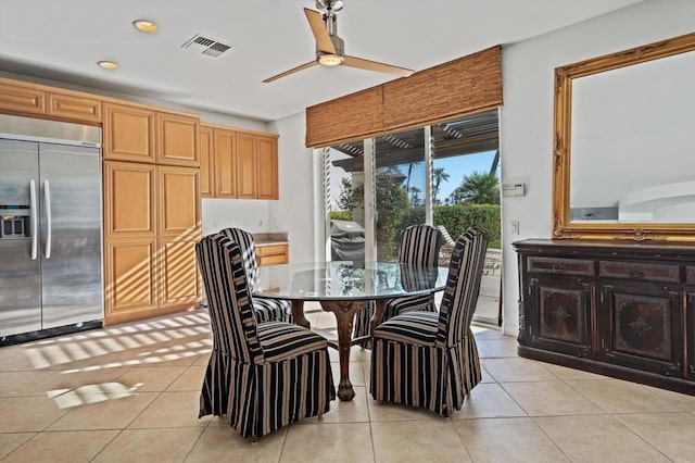 tiled dining area with ceiling fan