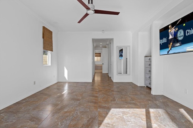 spare room with ceiling fan and crown molding