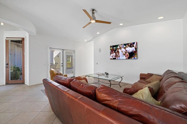 tiled living room featuring ceiling fan, french doors, and vaulted ceiling