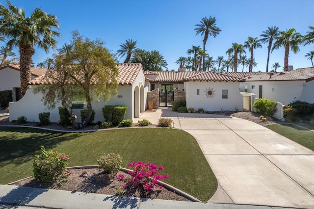 mediterranean / spanish house featuring a front yard